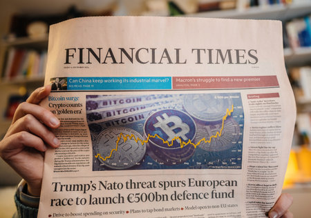 Paris, France - Dec 9, 2024: Person holding the Financial Times featuring a headline on Bitcoin...