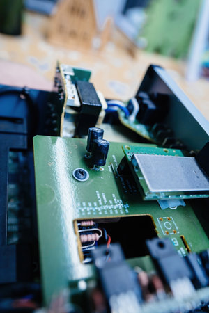 Detailed view of an optical drive with electronic components and wiring inside a device, showing internal tech mechanismsの写真素材