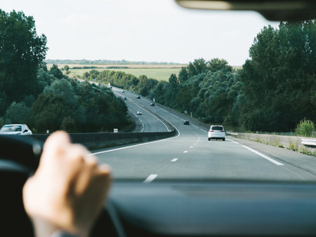 A driver's perspective on a French highway, with clear skies and open roads, embodying the freedom of road travel in Europeの写真素材