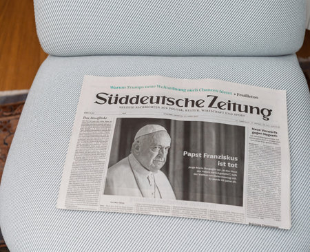 Paris, France - Apr 22, 2025: German newspaper on a cushioned chair with front-page obituary headline Papst Franziskus ist tot and monochrome portrait of Pope Francis after his deathのeditorial素材