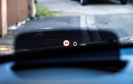 Close-up of a cars head-up display in an electric vehicle projecting a 30 kmh speed limit sign and...