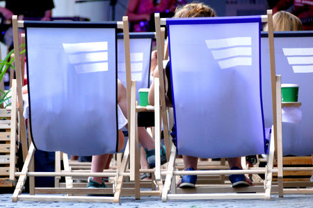 People sit on deckchairs and take part in a cultural event. They are relaxed and rest.のeditorial素材