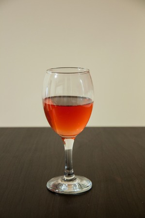 Glass of wine isolated on the tableの写真素材
