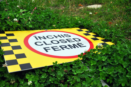 Close sign fallen in the grass
