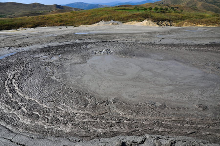 Huge gray mud volcano erupting