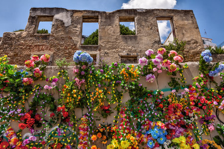 Wall covered with fake multicolored flowersの写真素材