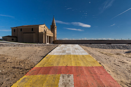 plastic coloured tape on the sand with a churchの写真素材