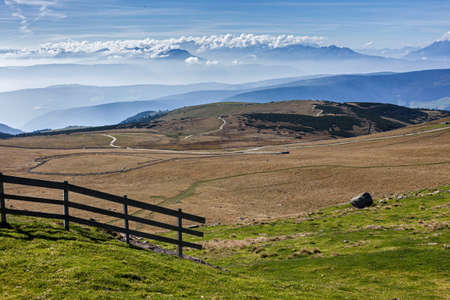 Panoramic view of mountain pastures with a wooden fenceの写真素材