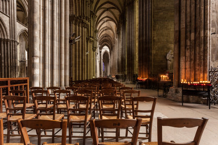 inside a Gothic cathedral with lit candlesのeditorial素材