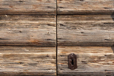 old iron lock on a wooden doorの写真素材