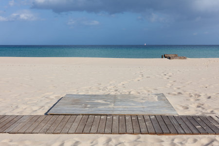 sand beach in front of the turquoise sea in Sardiniaの写真素材