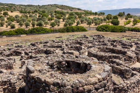 nuragic ruins of the archaeological site of Barumini in Sardinia with a round towerの写真素材