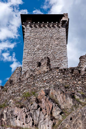 tower and bastions of a stone fort on a rock cliffの写真素材