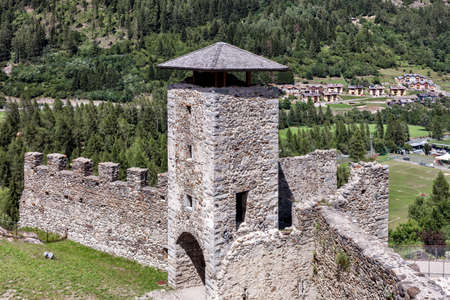 tower and bastions of a stone fort on a rock cliff overlooking the valleyの写真素材