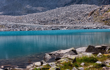 turquoise high mountain lake in the middle of the rocksの写真素材