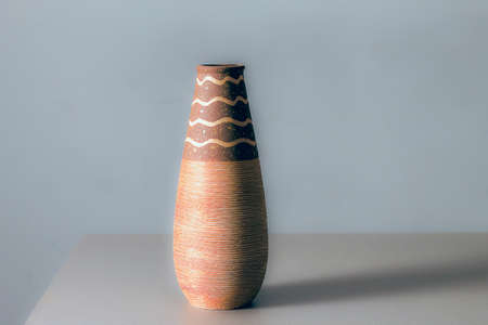terracotta pot on gray shelf and grey backgroundの写真素材
