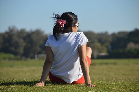 Young woman rests on the grass in the park Camet of the city of Mar del Plata, Argentinaの写真素材