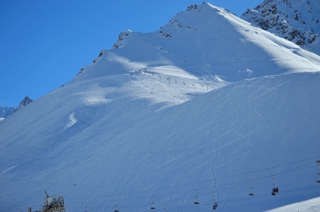 Snow-covered hillside striped by skiers and snowboards in Las Leñas, Mendoza, Argentinaの写真素材