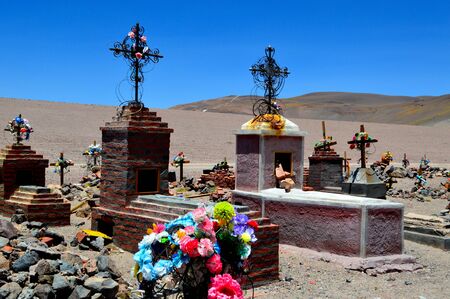 Picturesque tombs in the La Casualidad mine cementery. The sulfur line is observed on the back hill. Salta, Argentina.の写真素材