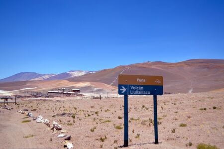 Overview of the La Casualidad mine with the sign indicating the direction to go to the sacred volcano LLullaillaco, Salta, Argentinaの写真素材