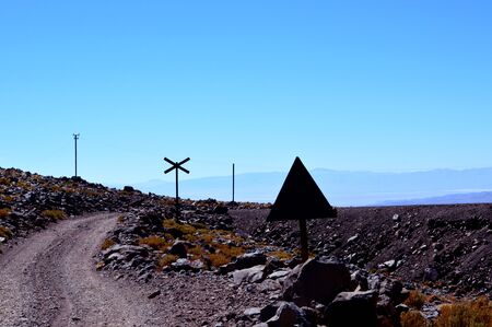 The road and the train tracks intertwined in the puna between Caipe and Socompa. Salta, Argentinaの写真素材