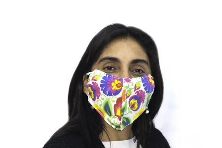 Young woman poses cheerfully with her chinstrap or mask. Positive attitude towards the coronavirus COVID 19 pandemicの写真素材