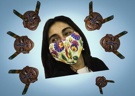 Young woman poses cheerfully with her chinstrap or mask. Positive attitude towards the coronavirus COVID 19 pandemicの写真素材