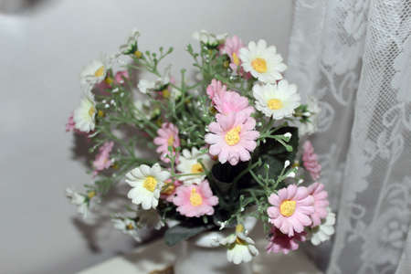 Pink and white flowers bouqet in a dormの写真素材