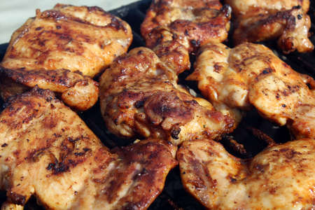 Chicken wings getting grilled on open fireの写真素材