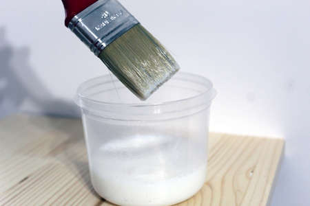 Paint brush with water based colorless lacquerの写真素材