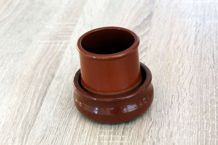 Romanian traditional ceramic pot from Horezu isolated on wood backgroundの写真素材