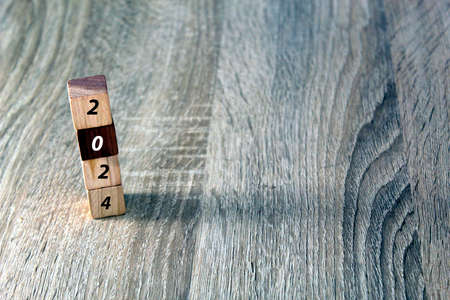 Wooden cubes with 2023 and happy new year over wooden background, banner with copy space for text, new year greeting card templateの写真素材