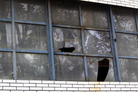 Old industrial building facade. Abandoned production. Broken windowsの写真素材