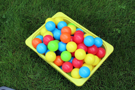 A lot of color ballpits inside a box in a grass fieldの写真素材