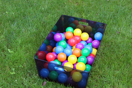 A lot of color ballpits inside a box in a grass fieldの写真素材