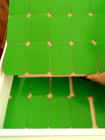 Green Painted Metal Plates in Organized Storage Drawerの写真素材