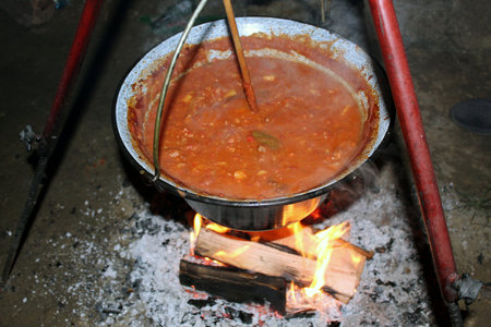 Traditional goulash cooking over open wood fireの写真素材