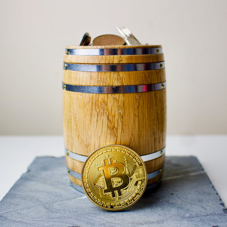 Gold bitcoin in barrelのeditorial素材