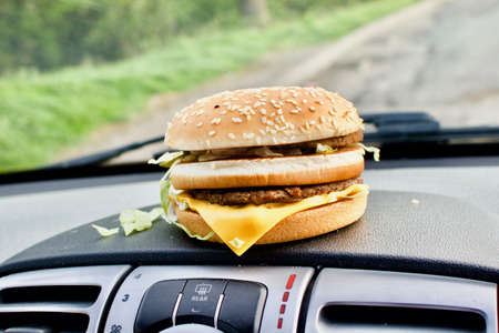 Tasty cheeseburger on the carの写真素材