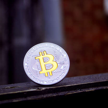Cryptocurrency silver bitcoin coin with yellow currency sign.のeditorial素材