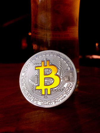 Cryptocurrency physical silver bitcoin coin with yellow signの写真素材