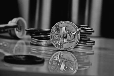 Cryptocurrency physical silver litecoin coin near moneyの写真素材