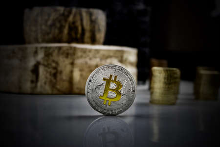 Cryptocurrency physical silver bitcoin coin with yellow signの写真素材
