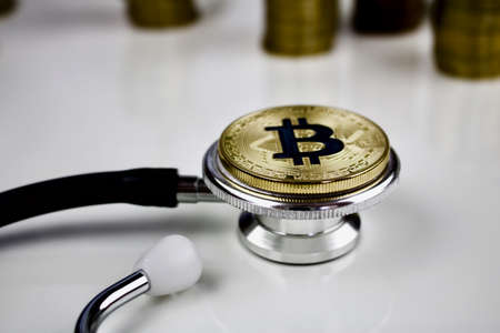 Cryptocurrency medical concept with a gold bitcoin coinの写真素材