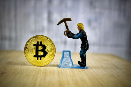 Cryptocurrency physical gold bitcoin coin. Mining man.の写真素材
