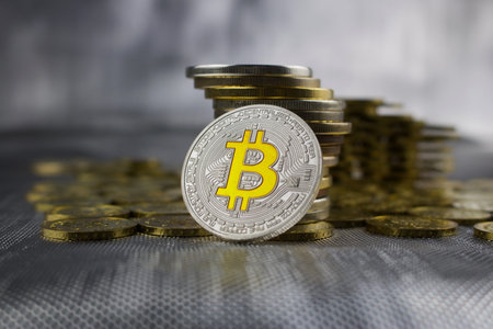 Cryptocurrency physical silver bitcoin coin near money.