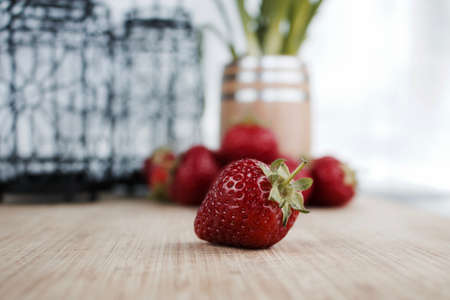 Big red fresh strawberry on the wooden board. Kitchen concept.の写真素材
