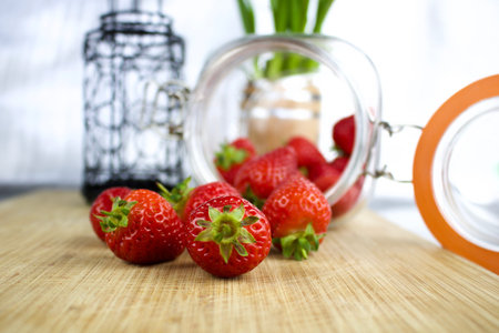 Red and fresh strawberries from jar in the kitchen. Fruit conceptの写真素材