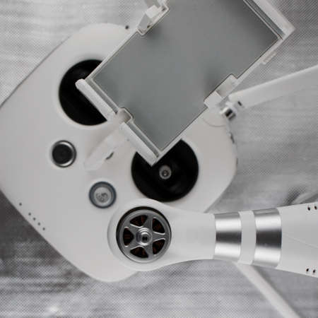 White drone arm near white aircraft hand controller.の写真素材
