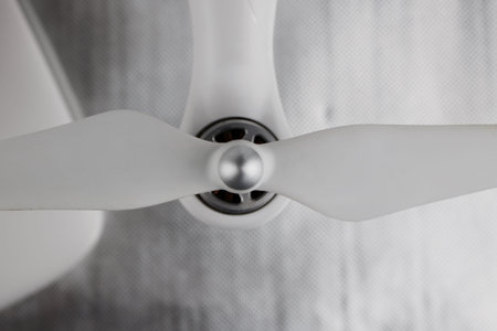 White long airscrew on the white quadcopter with silver engine.の写真素材